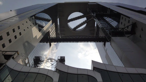 a view looking up that includes the metal entrance accents